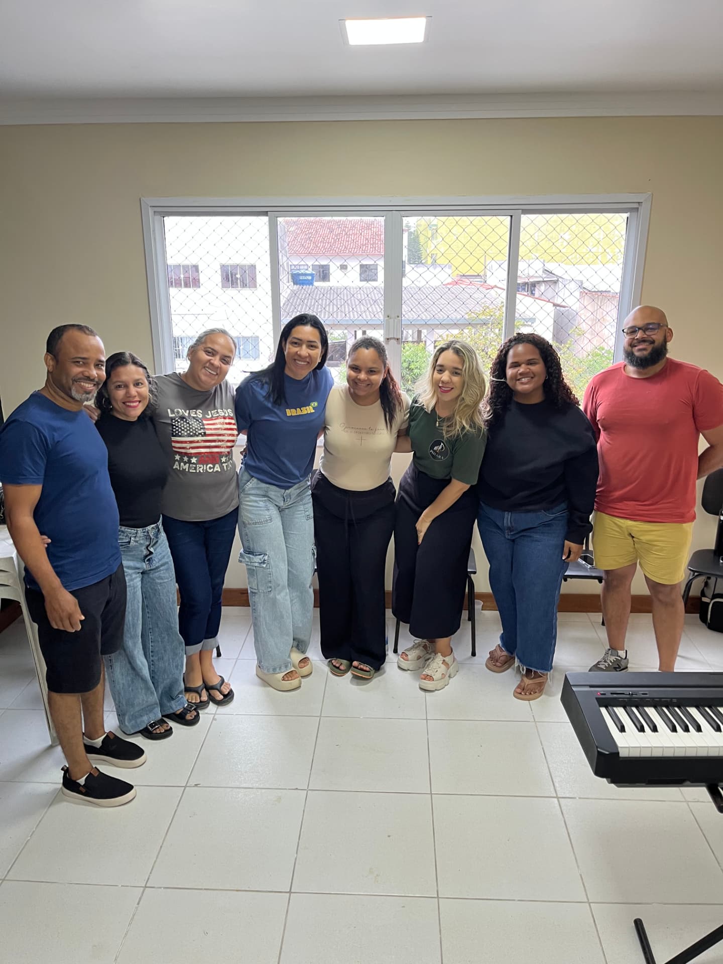 Turma de canto em grupo formada por jovens e adultos reunidos na sala de aula